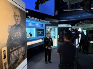 U.S. Navy Commander Thelmar A. Rosarda stands inside the National Medal of Honor Museum & Heritage Center during an on-site interview, sharing his journey from Chattanooga student to military leader and his commitment to service.