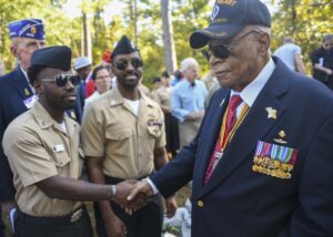 Hospital Corpsman Clarence Outler Jr. (left) and Hospital Corpsman Second Class Kenneth Stith Jr. meet Major James Capers Jr. Capers was a guest speaker at the dedication ceremony for the Corpsmen Memorial on October 12, 2022 in Jacksonville, North Carolina.