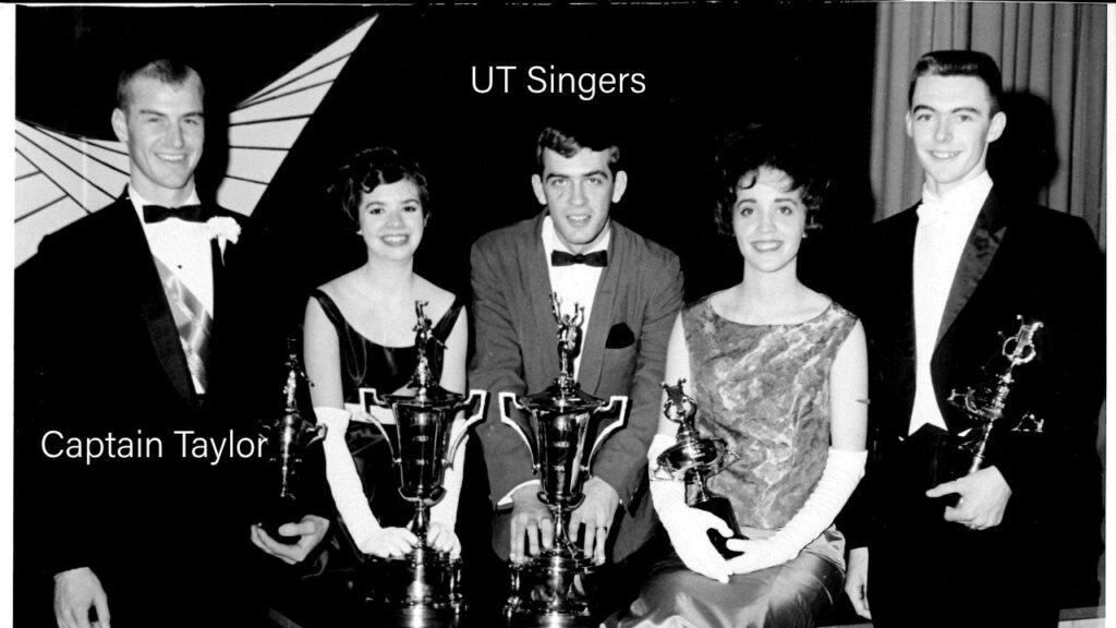 A group of young people stand with trophies after winning a singing competition.